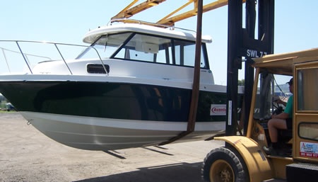 Boat Terminal Transport & Storage - Loading a new boat for delivery